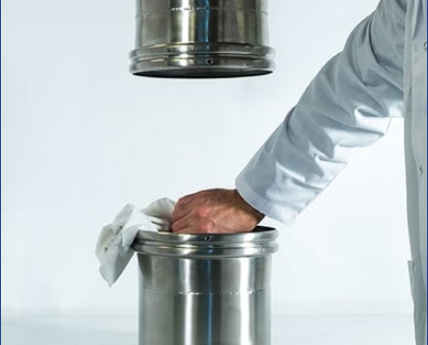 Plant employee cleaning out a powder manufacturing tube 